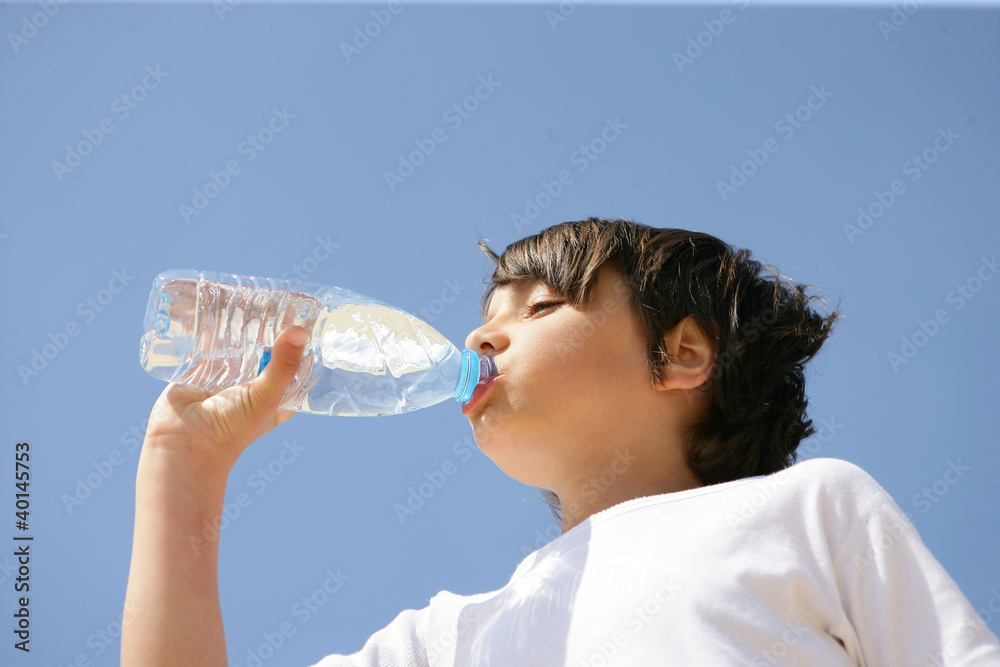Little boy drinking from bottle of water Little boy drinking from bottle of water
