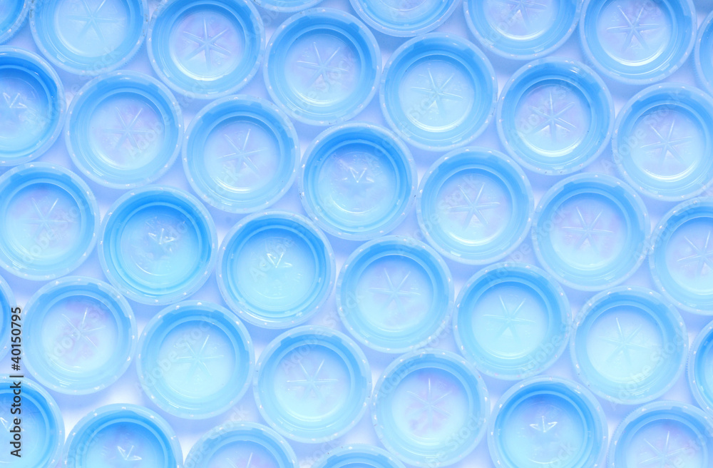 a lot of blue plastic bottle screw caps
