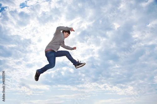 Young man jumping for joy in the air photo