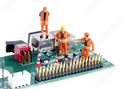 tiny construction engineers figures examine integrated circuit photo