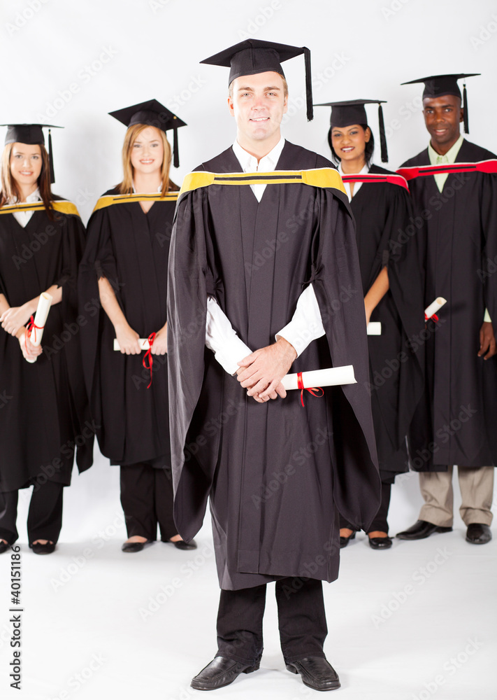 male college student at graduation with classmates male college student at graduation with classmates