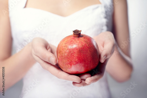 hand with pomegranate