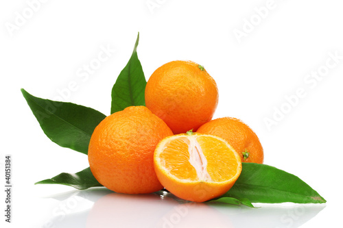 Ripe tasty tangerines with leaves and segments isolated on white