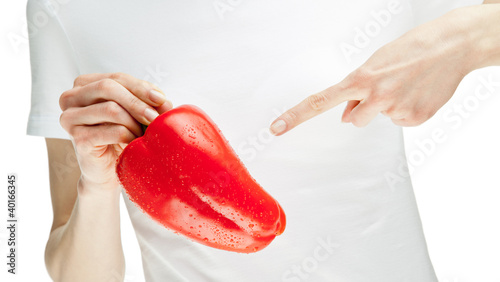 Woman holding fresh red sweet pepper