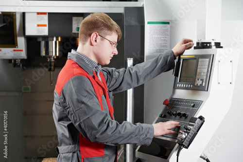 laborer working with machine tool photo