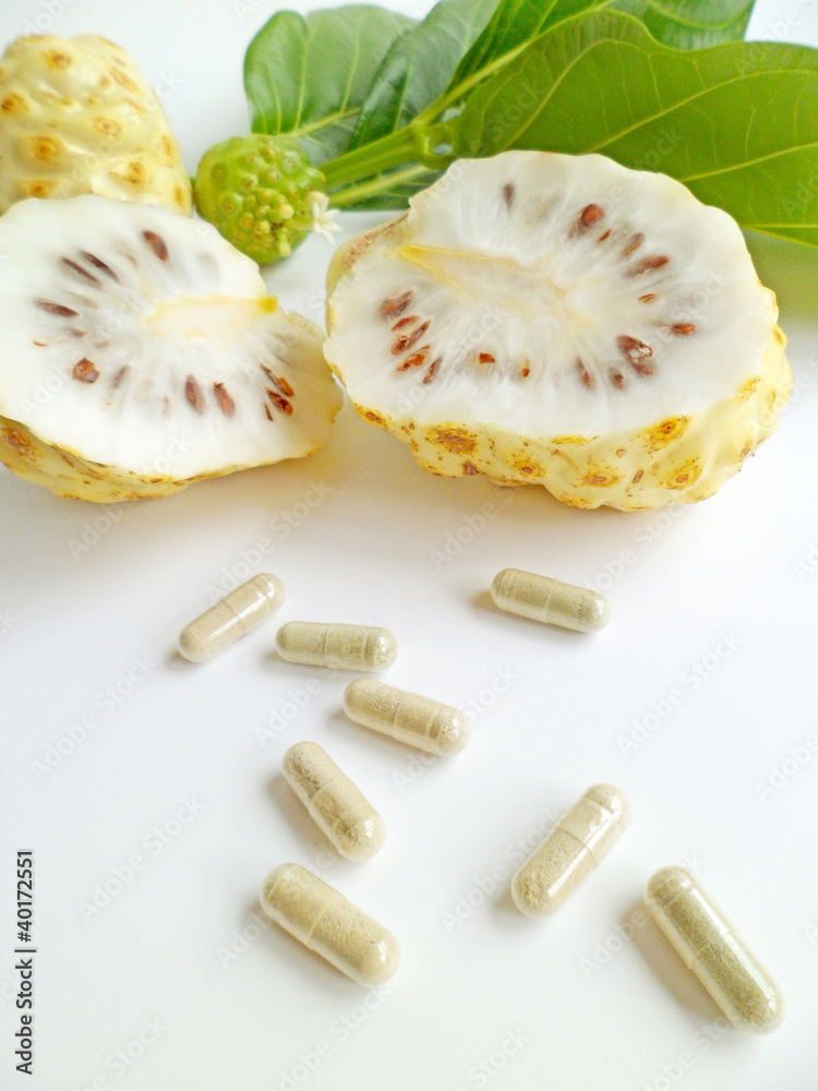Noni fruits (Morinda citrifolia) and capsules Noni fruits (Morinda citrifolia) and capsules