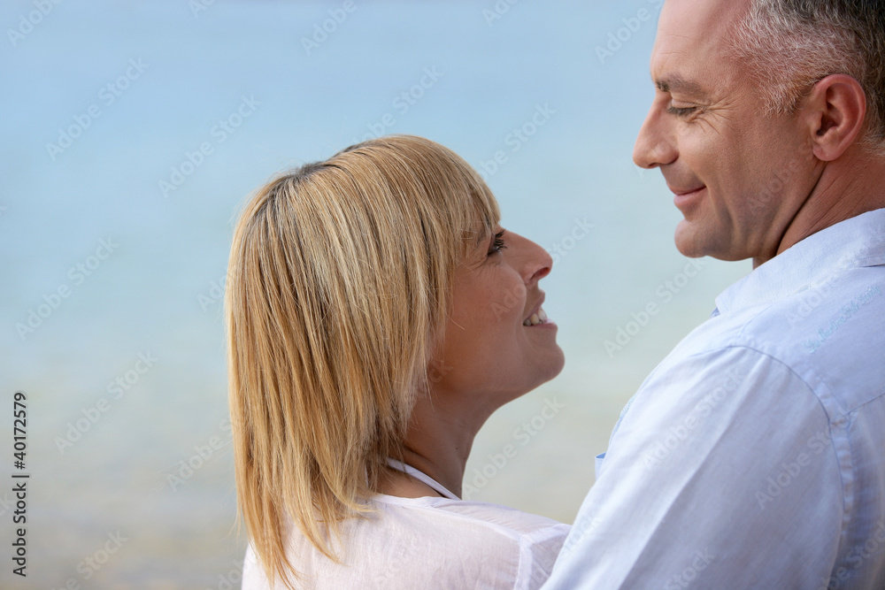 Fototapeta premium Mature couple smiling at the seaside
