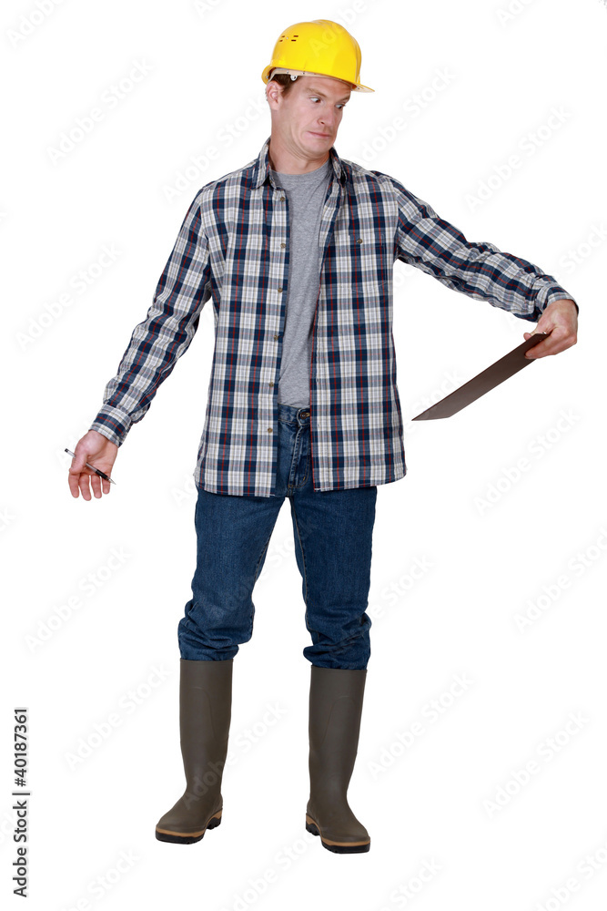 Construction worker confused by clip-board Construction worker confused by clip-board