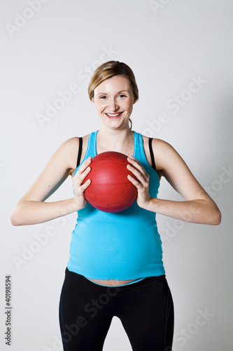 Pregnant woman holding an exercise ball