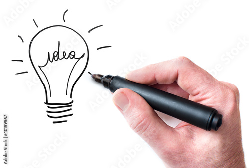 Hand drawing Idea bulb on whiteboard photo