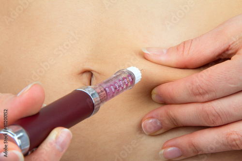 Diabetes patient make insulin injection shot by syringe in abdom