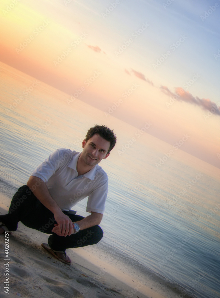 Attractive man on a beach with sunset / sunrise (Maldives)