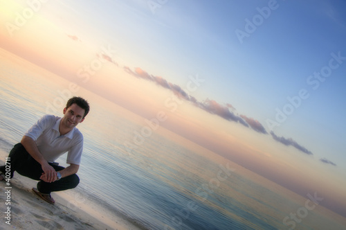 Fototapeta Naklejka Na Ścianę i Meble -  Attractive man on a beach with sunset / sunrise (Maldives)