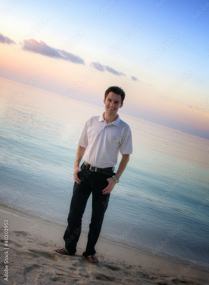 Attractive man on a beach with sunset / sunrise (Maldives) Attractive man on a beach with sunset / sunrise (Maldives)