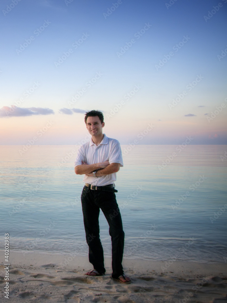 Attractive man on a beach with sunset / sunrise (Maldives) Attractive man on a beach with sunset / sunrise (Maldives)