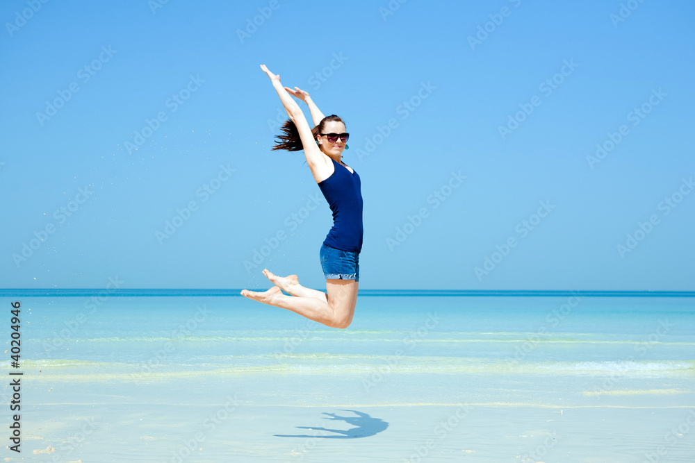 Young beautiful woman posing on the beach Young beautiful woman posing on the beach