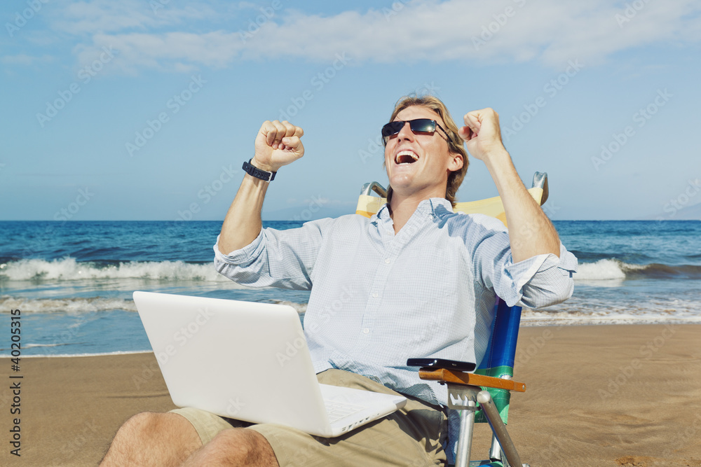 Young Attractive Man Celebrating Success, Working on Computer at