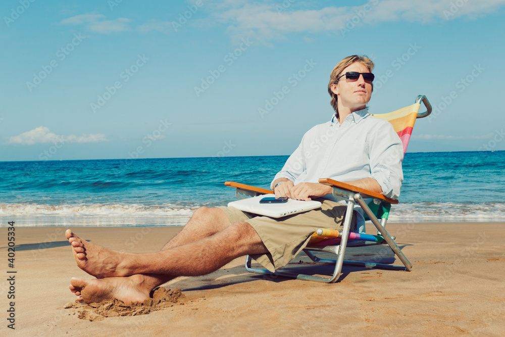 Young Attractive Man Relaxing at the Beach with Laptop Computer
