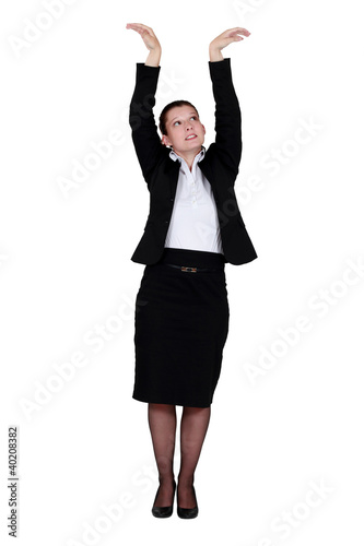 Businesswoman reaching up