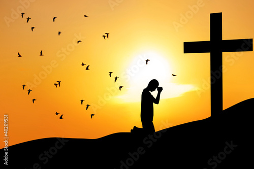 Photography Christian background: man praying under the cross
