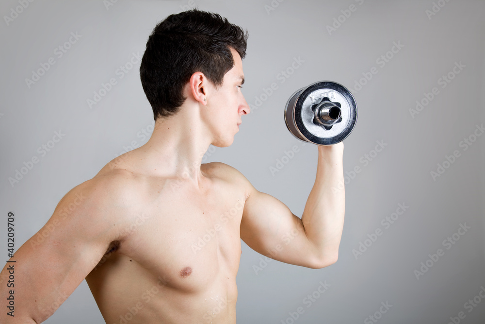 Muscular man lifting weights. Side view. Muscular man lifting weights. Side view.