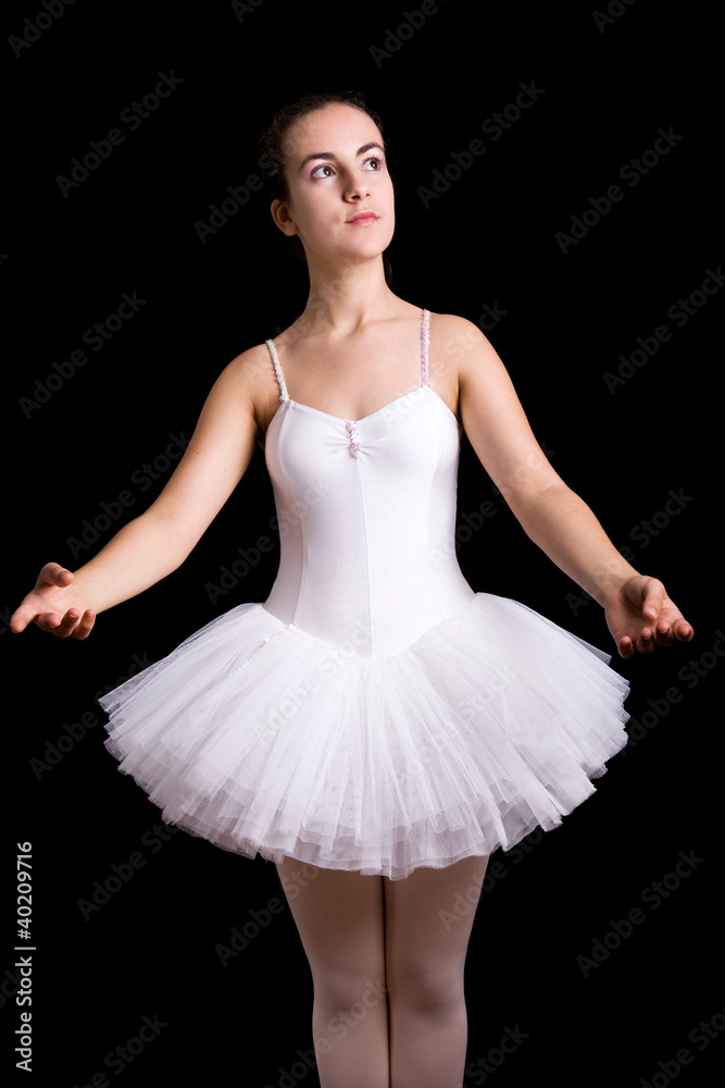 Ballerina posing against black background
