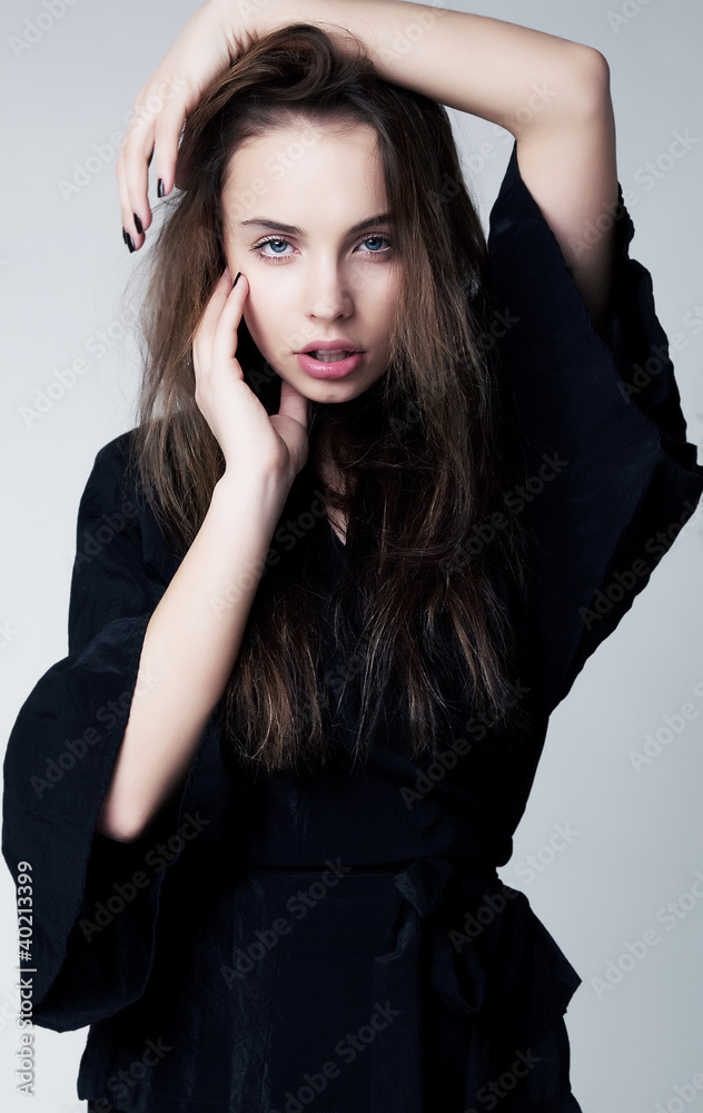 Beautiful sensual teen girl in black dress with long hair
