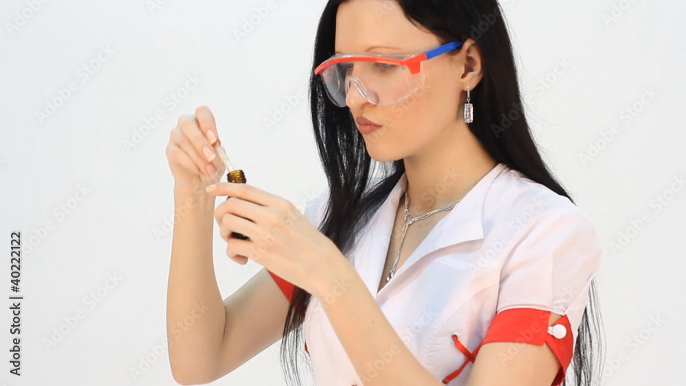 laboratory assistant analyzing a liquid