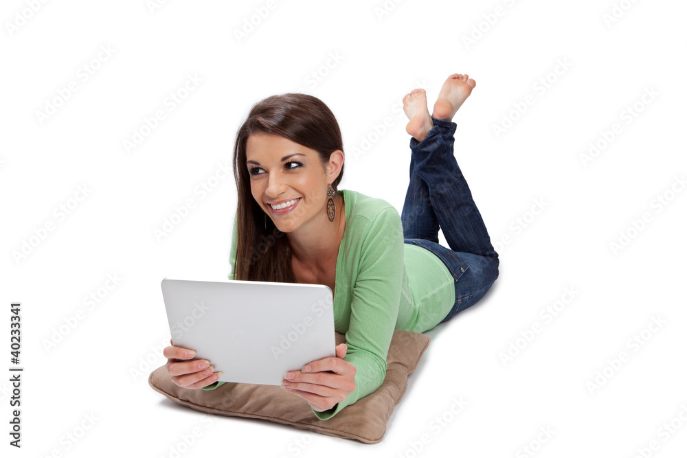 Olive skin woman smiles while surfing the web on a tablet Olive skin woman smiles while surfing the web on a tablet