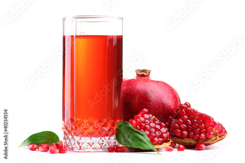 ripe pomergranate and glass of juice isolated on white.