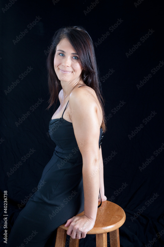 Pretty woman in black smiling at the camera Pretty woman in black smiling at the camera