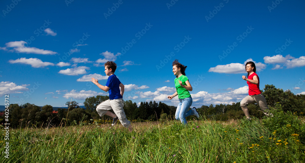 Active family - mother and kids running, jumping outdoor Active family - mother and kids running, jumping outdoor