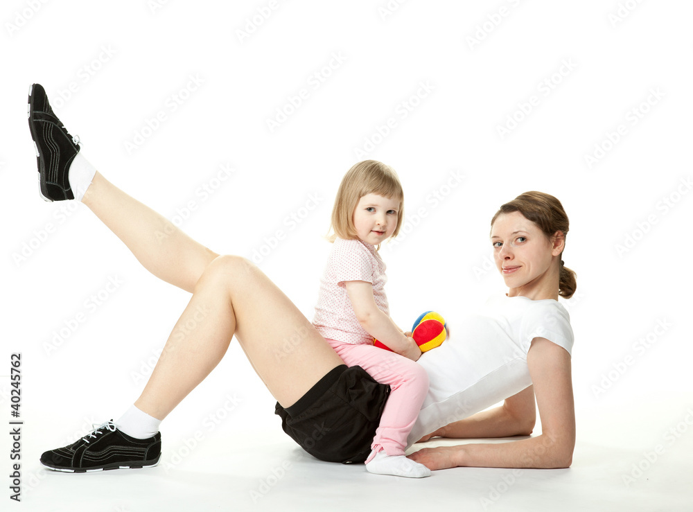 Young woman and her daughter doing sport exercises Young woman and her daughter doing sport exercises