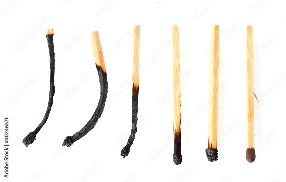 burnt matches and one whole match isolated on white burnt matches and one whole match isolated on white
