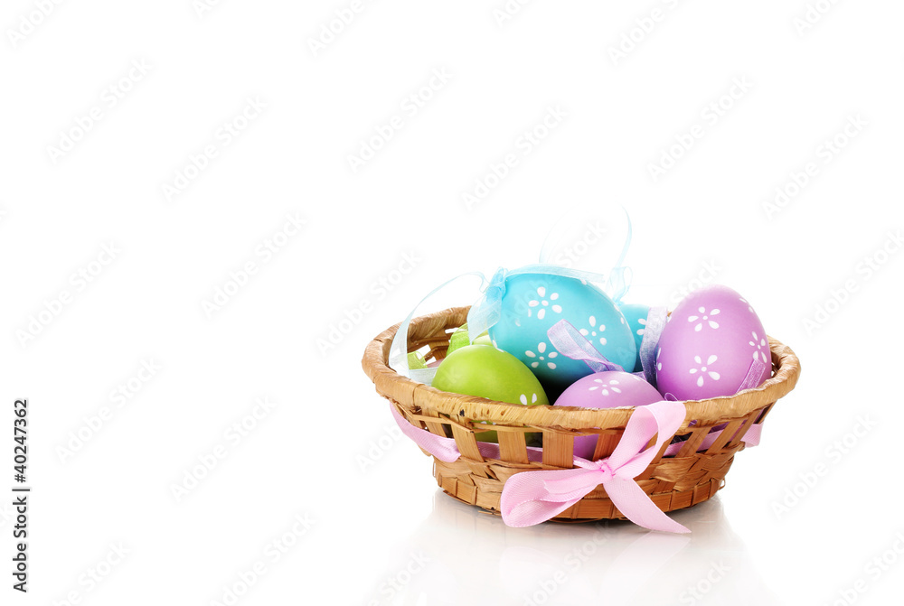 Colorful easter eggs in basket isolated on white Colorful easter eggs in basket isolated on white