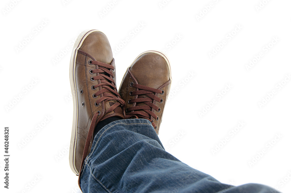 male legs in sneakers and jeans lying male legs in sneakers and jeans lying