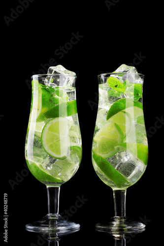glasses of cocktails with lime and mint on black background #40248719