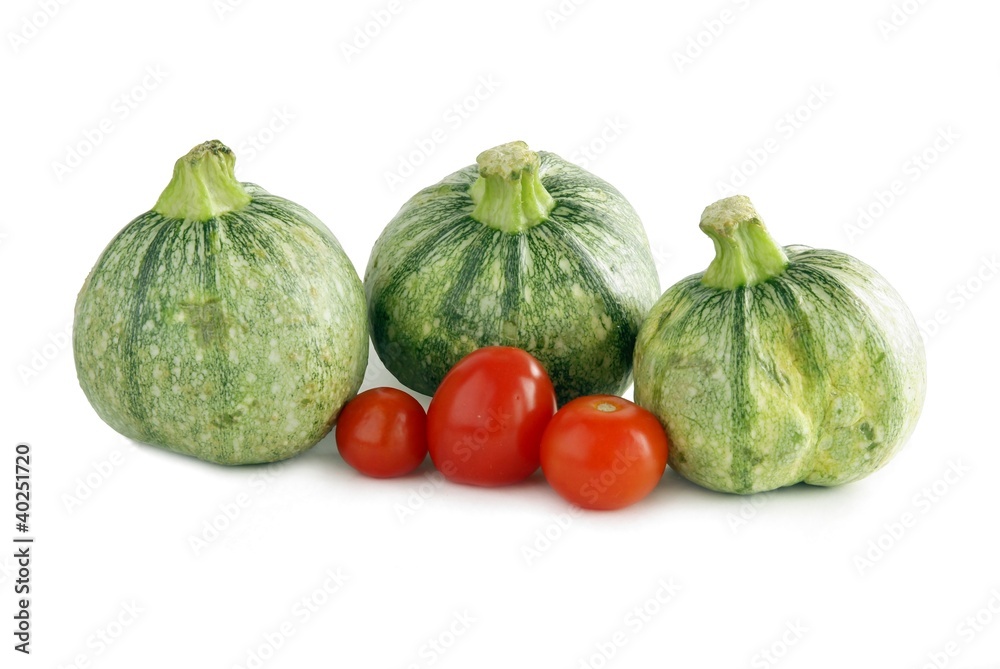 green early young pumpkins and small red tomato green early young pumpkins and small red tomato