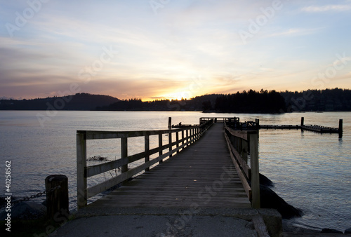 sunset over wooden pier in Anmore ,British Coloumbia photo