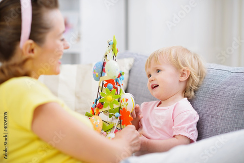 Mother and baby playing with Easter decoration
