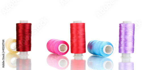 Many spools of thread isolated on white