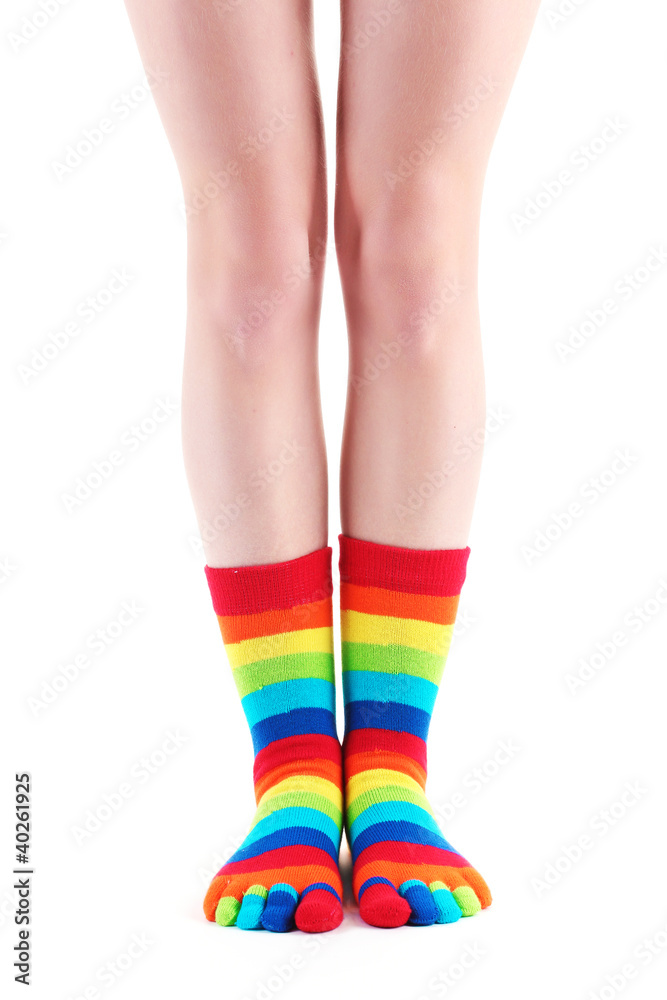 female legs in colorful striped socks isolated on white