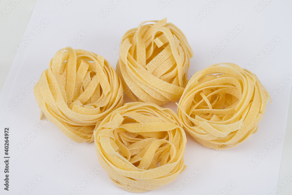 Italian pasta fettuccine nest isolated on white background Italian pasta fettuccine nest isolated on white background