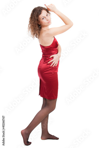 Young woman in red dress isolated on white background. © Aliaksei Hintau