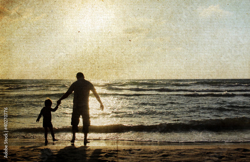 father and son on the sea. Photo in old color image style.