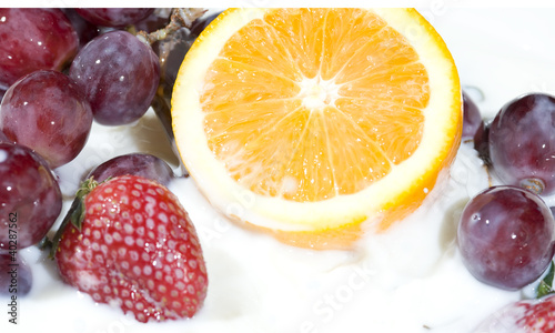 Splashing milk with fruit and berry