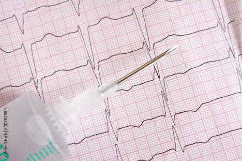 metal medical needles on the background paper ECG