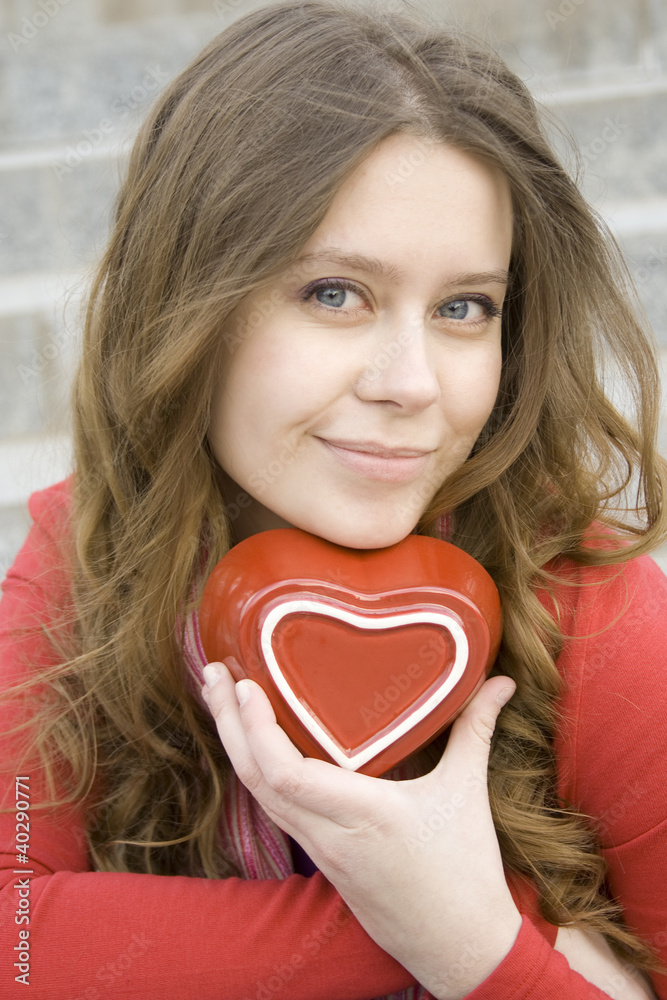 Attractive woman holding a red heart