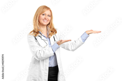 A smiling mature healthcare practitoner gesturing