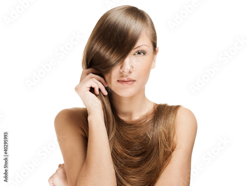 beautiful young woman holding her elegant long shiny hair